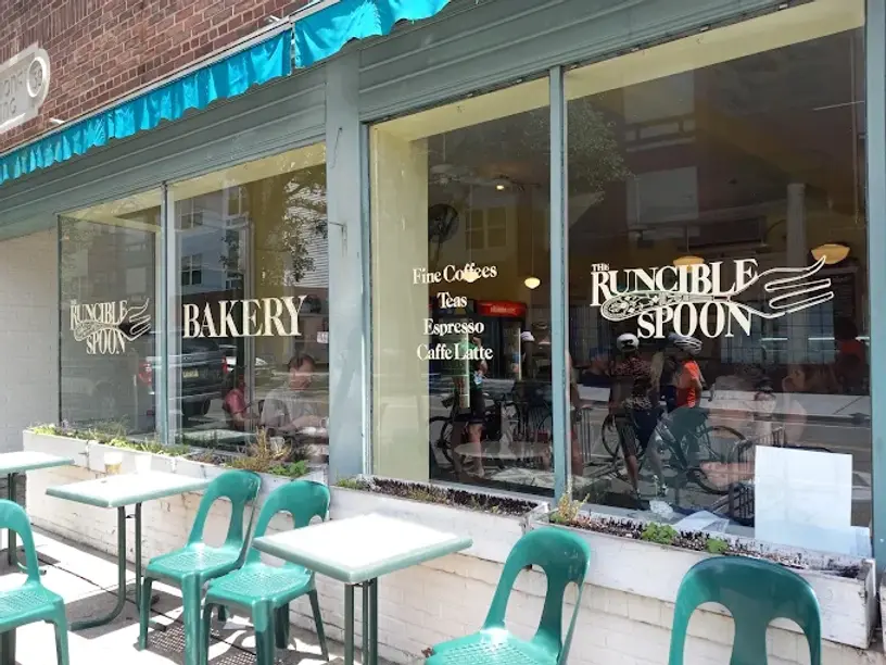 Runcible Spoon Bakery sign and window display with tables and chairs.